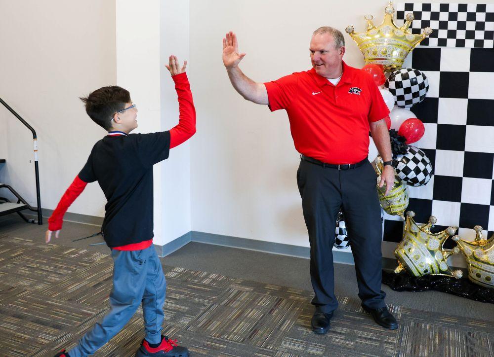 Mr. Byrd giving a high-five to a student